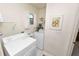 Functional laundry room includes a washer, dryer, shelving, and a window for natural light at 3315 Cross Fox Dr, Mulberry, FL 33860