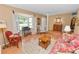 Inviting living room with hardwood floors, a large window, and comfortable seating, adjacent to the entry at 3315 Cross Fox Dr, Mulberry, FL 33860