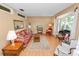 Spacious living room with a large window, cozy floral sofa, and classic furnishings on hardwood floors at 3315 Cross Fox Dr, Mulberry, FL 33860