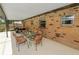 Cozy screened-in patio with brick exterior and a glass table, great for entertaining at 3315 Cross Fox Dr, Mulberry, FL 33860
