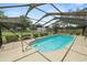 Beautiful view of a screened-in pool, surrounded by well-maintained landscaping and a secure fence at 3315 Cross Fox Dr, Mulberry, FL 33860