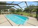 Sparkling in-ground pool surrounded by a screened enclosure and lush landscaping at 3315 Cross Fox Dr, Mulberry, FL 33860