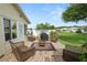Backyard brick patio with seating, grill, and manicured landscaping at 3370 Highland Fairways Blvd, Lakeland, FL 33810