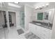 Bathroom featuring a shower with glass doors, granite counters, and modern vanity at 3370 Highland Fairways Blvd, Lakeland, FL 33810