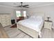 Bright bedroom featuring wood-look floors, a ceiling fan, and a sitting area near the window at 3370 Highland Fairways Blvd, Lakeland, FL 33810