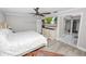 Comfortable bedroom with wood-look floors, a ceiling fan, and a TV at 3370 Highland Fairways Blvd, Lakeland, FL 33810