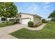 Well-maintained home with an attached garage, landscaped bushes and a vibrant green lawn at 3370 Highland Fairways Blvd, Lakeland, FL 33810