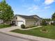 Inviting single-story home featuring an attached garage, tidy lawn, and mature landscaping at 3370 Highland Fairways Blvd, Lakeland, FL 33810
