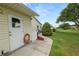 Exterior walkway leading to a neatly maintained lawn and patio area at 3370 Highland Fairways Blvd, Lakeland, FL 33810