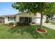 Charming home featuring a well-manicured lawn, mulch landscaping, and a welcoming screened in porch at 3370 Highland Fairways Blvd, Lakeland, FL 33810