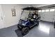 Garage featuring an electric golf cart with custom wheels and seats at 3370 Highland Fairways Blvd, Lakeland, FL 33810