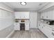 Eat-in kitchen featuring white cabinets, gray countertops, stainless appliances, and breakfast bar at 3370 Highland Fairways Blvd, Lakeland, FL 33810