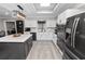 Bright eat-in kitchen with white cabinets, stainless appliances, and island with breakfast bar at 3370 Highland Fairways Blvd, Lakeland, FL 33810