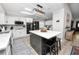 Modern kitchen featuring a large island with seating, stainless steel appliances, and stylish lighting at 3370 Highland Fairways Blvd, Lakeland, FL 33810