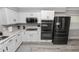 Kitchen features stainless steel appliances, white cabinets, and modern fixtures at 3370 Highland Fairways Blvd, Lakeland, FL 33810