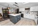 Spacious kitchen with an island, white cabinets, modern lighting, and an adjacent dining area at 3370 Highland Fairways Blvd, Lakeland, FL 33810
