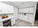 Kitchen area with white cabinets, gray countertops, breakfast bar, and stainless appliances at 3370 Highland Fairways Blvd, Lakeland, FL 33810