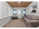 Bright living room with a wood ceiling, natural light, and comfortable sofa at 3370 Highland Fairways Blvd, Lakeland, FL 33810