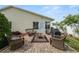 Backyard brick patio featuring wicker furniture and a grill for entertaining at 3370 Highland Fairways Blvd, Lakeland, FL 33810