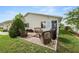 Backyard brick patio with wicker furniture and grill perfect for entertaining at 3370 Highland Fairways Blvd, Lakeland, FL 33810