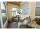Comfortable screened-in porch with wicker seating, plants, and a view of the quiet neighborhood at 3370 Highland Fairways Blvd, Lakeland, FL 33810