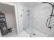 Close up of the walk-in shower featuring grey-toned tile and glass door at 3370 Highland Fairways Blvd, Lakeland, FL 33810