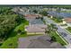 A house situated in a serene neighborhood with a lake nearby, as seen from an aerial perspective at 3427 Waterlute Way, Lakeland, FL 33811