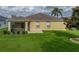 Home back exterior with a large yard and screened-in patio, perfect for entertaining at 3427 Waterlute Way, Lakeland, FL 33811