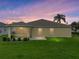 Home back exterior with a large yard and screened-in patio, perfect for entertaining at 3427 Waterlute Way, Lakeland, FL 33811