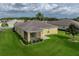 Back exterior featuring screened in porch, garden and lush lawn at 3427 Waterlute Way, Lakeland, FL 33811