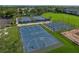 Aerial view of basketball and tennis courts surrounded by lush landscaping in a residential community at 3427 Waterlute Way, Lakeland, FL 33811