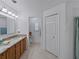 Spacious bathroom featuring a double sink vanity and handicap accessible toilet at 3427 Waterlute Way, Lakeland, FL 33811