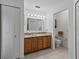 Bathroom featuring a double sink vanity and handicap accessible toilet at 3427 Waterlute Way, Lakeland, FL 33811