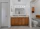 Bright bathroom featuring a double vanity with granite countertop and wood cabinets at 3427 Waterlute Way, Lakeland, FL 33811