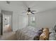 Bedroom featuring a ceiling fan, shutters, and a double door closet at 3427 Waterlute Way, Lakeland, FL 33811