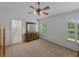 Bright bedroom with carpet, shutters, and a ceiling fan for comfort at 3427 Waterlute Way, Lakeland, FL 33811