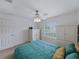 Bedroom featuring plantation shutters, ceiling fan, and closet space at 3427 Waterlute Way, Lakeland, FL 33811