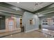 Welcoming common area with tiled floors, arched doorway, and a pass-through window to the kitchen area at 3427 Waterlute Way, Lakeland, FL 33811