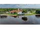 Community center situated on the water with a pool and lake views surrounded by mature trees at 3427 Waterlute Way, Lakeland, FL 33811