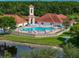 A large community pool surrounded by lush landscaping and lounge chairs for residents to enjoy at 3427 Waterlute Way, Lakeland, FL 33811