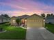 Charming single-story home with a well-manicured lawn and a two-car garage at 3427 Waterlute Way, Lakeland, FL 33811