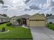 Charming single-story home with a well-manicured lawn and a two-car garage at 3427 Waterlute Way, Lakeland, FL 33811