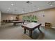 Spacious game room with multiple pool tables, ample lighting, and comfortable seating options at 3427 Waterlute Way, Lakeland, FL 33811