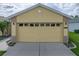 Spacious two-car garage with ample driveway parking and well-maintained landscaping at 3427 Waterlute Way, Lakeland, FL 33811