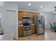 Well-equipped kitchen with stainless steel appliances, warm wood cabinets, and lots of counter space at 3427 Waterlute Way, Lakeland, FL 33811