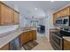 This well-equipped kitchen features stainless steel appliances, wooden cabinetry, and breakfast bar at 3427 Waterlute Way, Lakeland, FL 33811