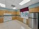 Functional kitchen equipped with stainless steel appliances and a wide window showcasing pool views at 3427 Waterlute Way, Lakeland, FL 33811