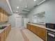 Well-equipped kitchen featuring light wood cabinets, modern appliances, and a convenient serving window at 3427 Waterlute Way, Lakeland, FL 33811