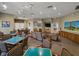 Community living room with tables and seating, many windows, and ceiling fans at 3427 Waterlute Way, Lakeland, FL 33811