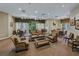 Community living room with tables and seating, many windows, and ceiling fans at 3427 Waterlute Way, Lakeland, FL 33811